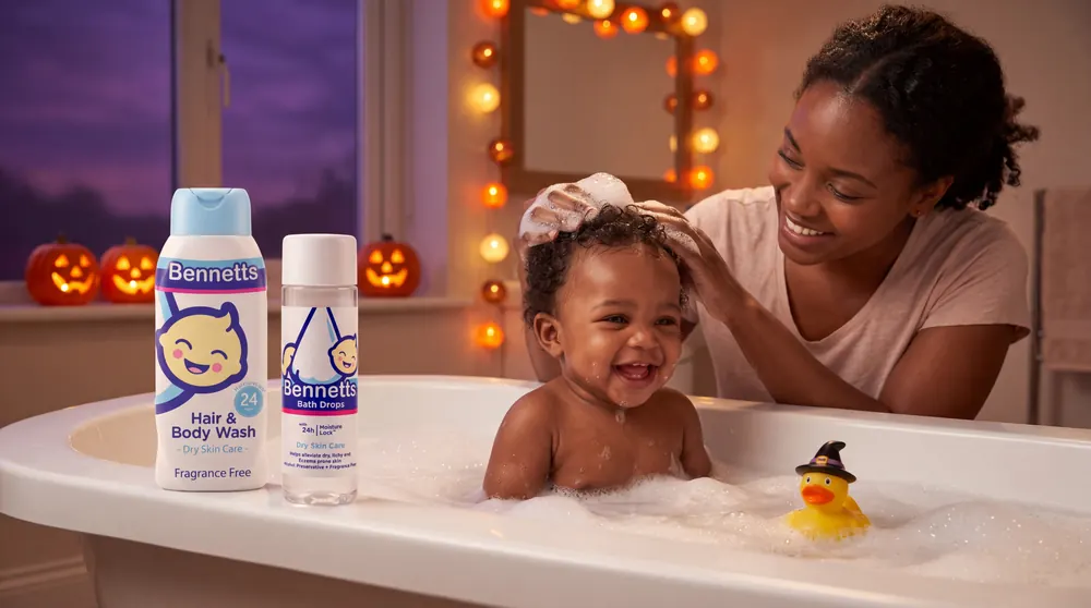 A mom washing her giggling baby’s hair in a bubble bath, with Bennetts Hair & Body Wash and Bath Drops on the rim